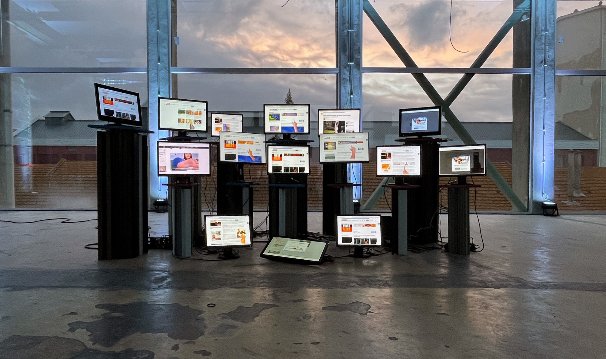 Installation of “Synthetic Messenger”: 15 screens on pedestals of different heights showing bots browsing the web.