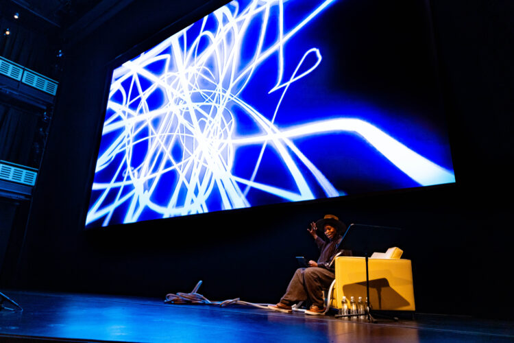 A stage with a blue and white futuristic projection.