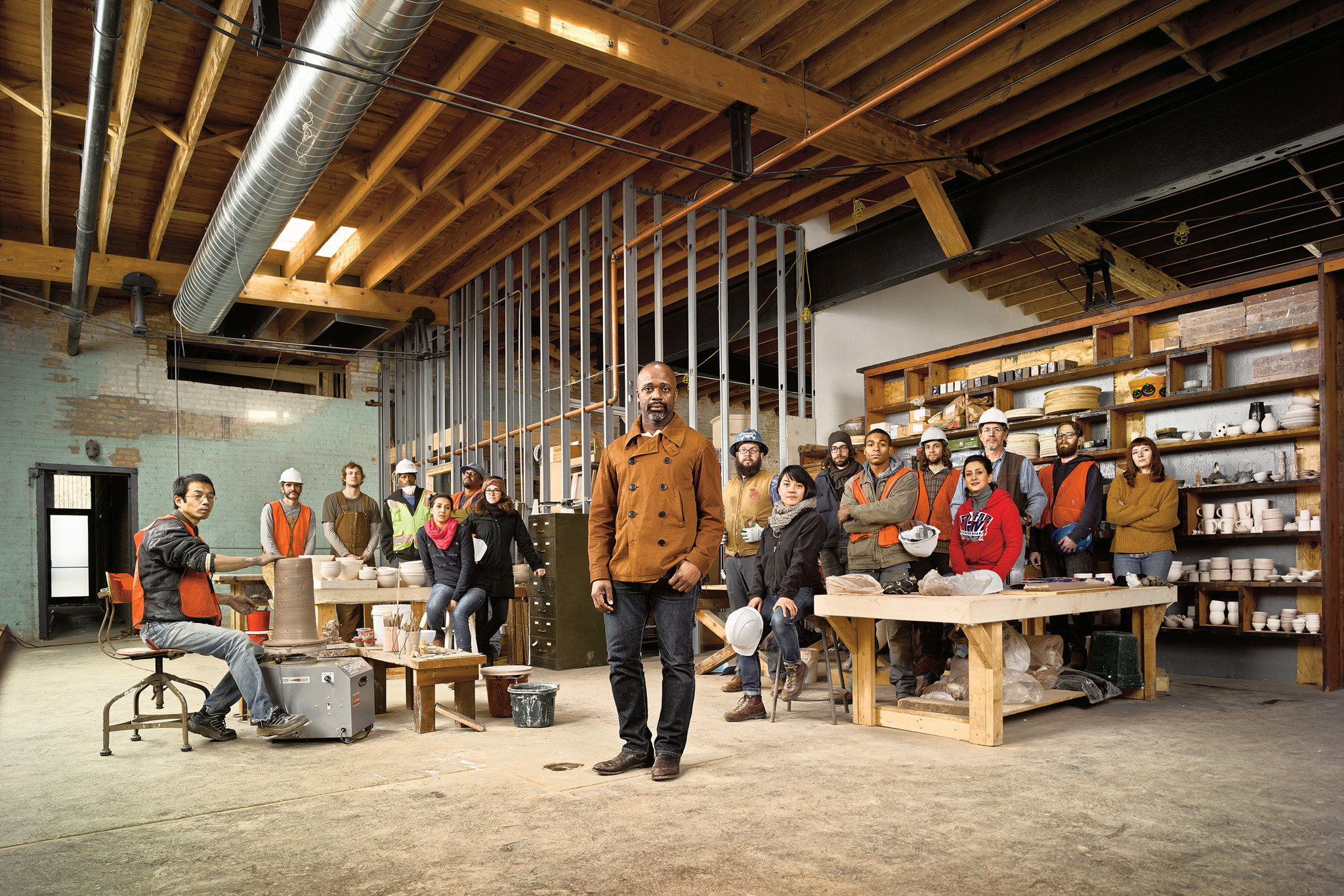 Theaster Gates (2012 Creative Capital Grantee) pictured with employees and artists in his pottery studio inside a converted beer warehouse in Chicago. Photo by Stephen Wilkes. 