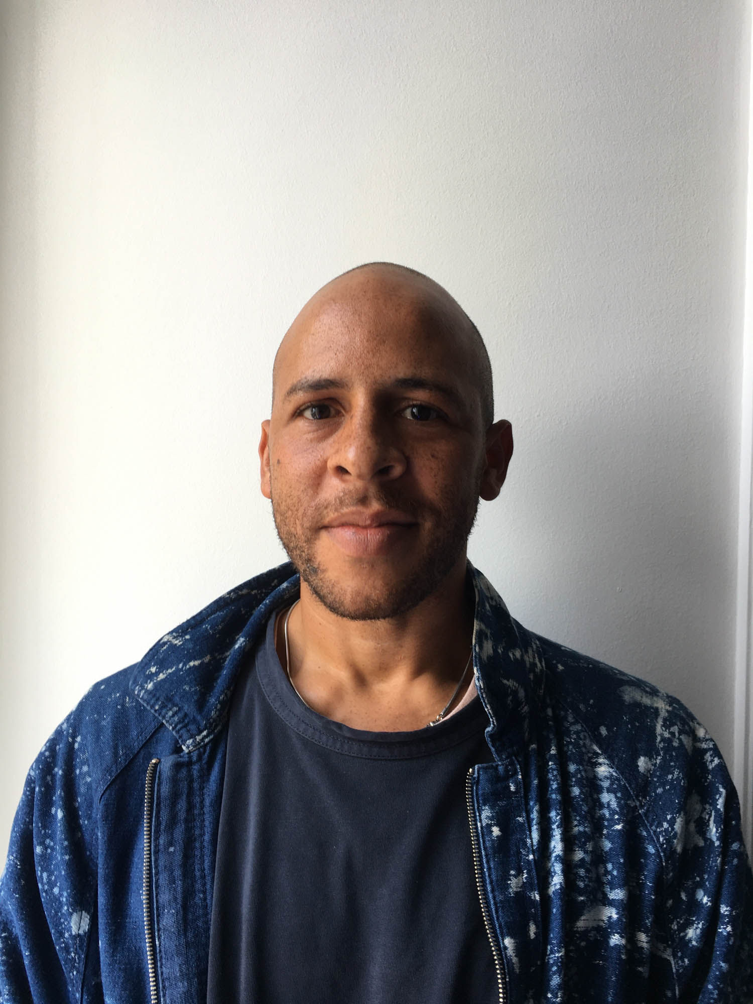 Will Rawls wearing a denim jacket against a wall