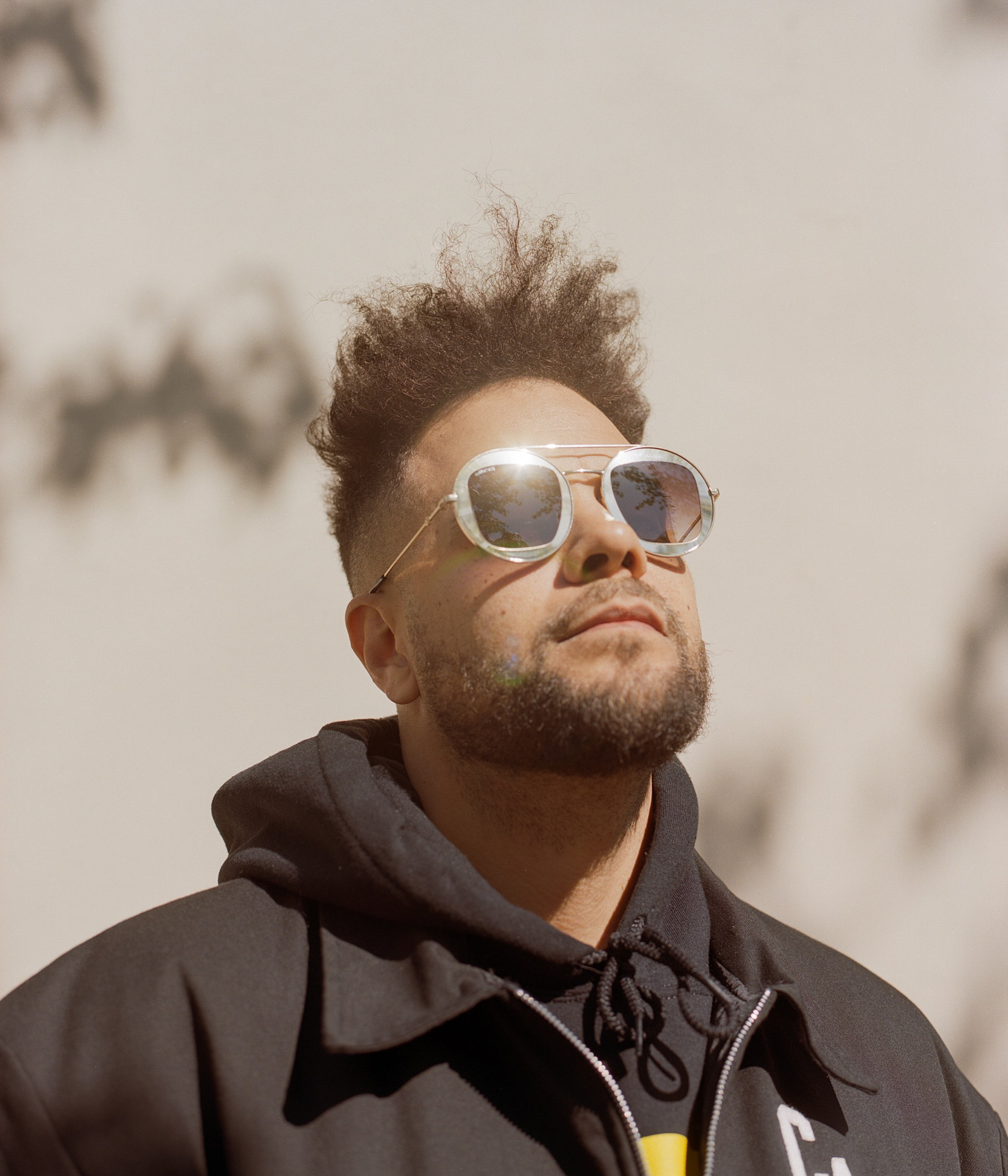 Kassa Overall Wearing Metallic Sunglasses