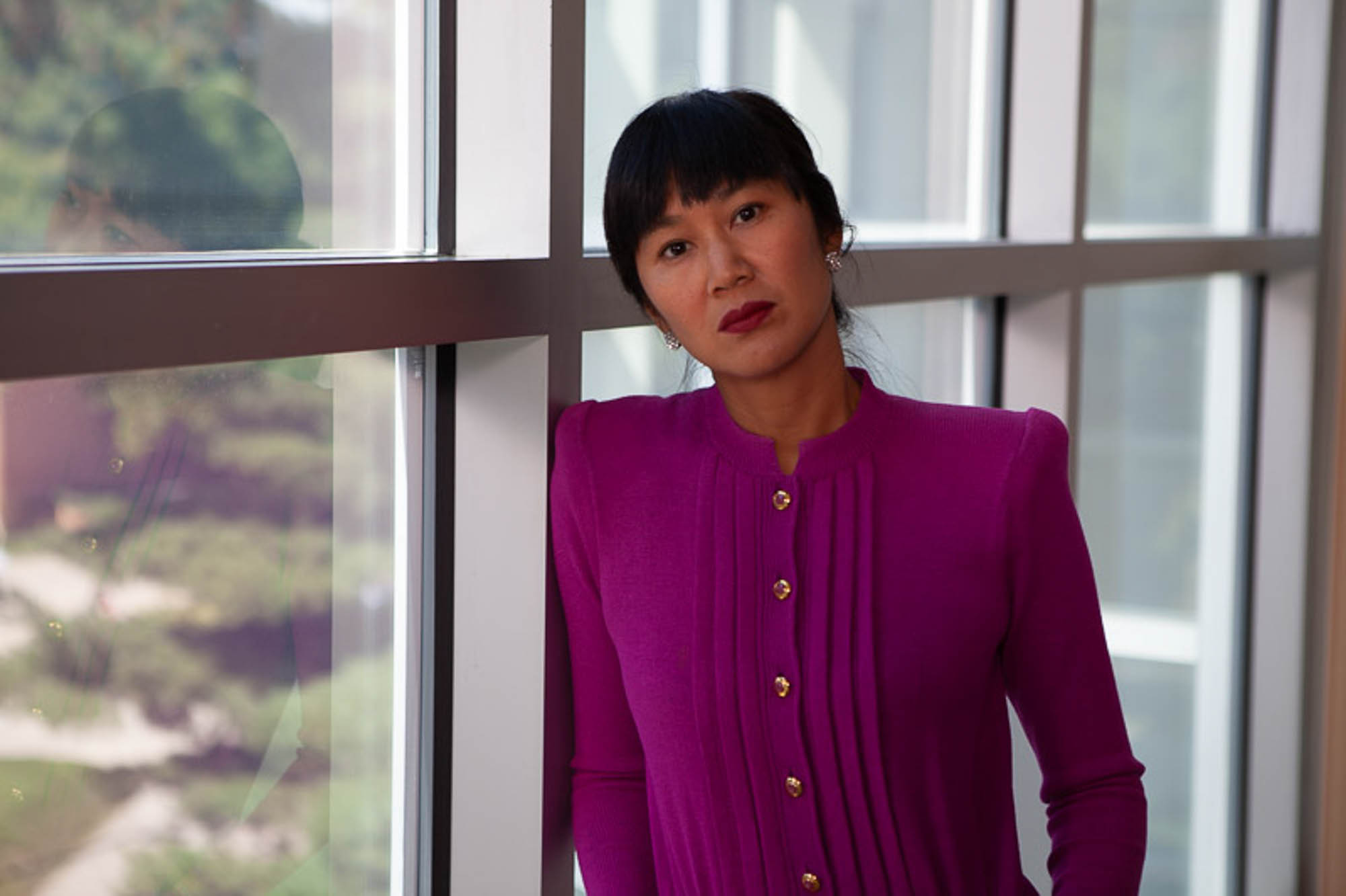 Stephanie Wang-Breal, dressed in a St. John knitwear suit, reflects upon the vast collection of American art on display at the Butler Institute of American Art.