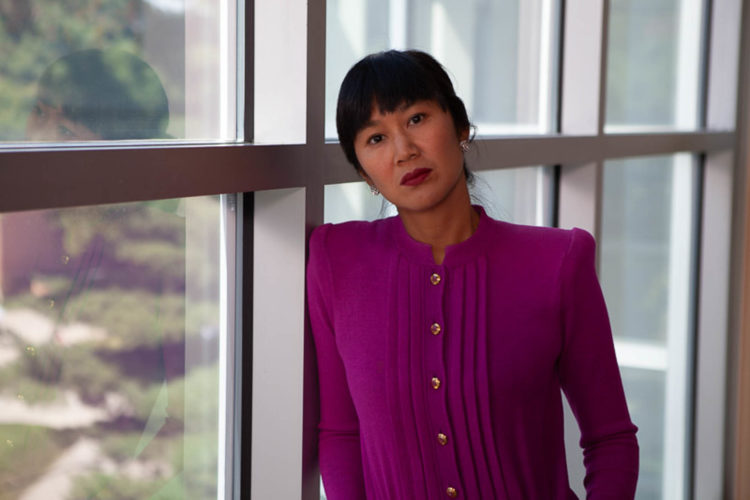 Stephanie Wang-Breal, dressed in a St. John knitwear suit, reflects upon the vast collection of American art on display at the Butler Institute of American Art. 