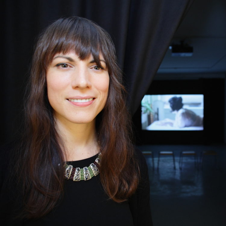 Carrie Schneider with her single-channel video projection “Reading Women,” on January 11, 2014.