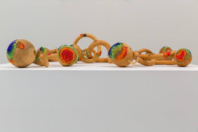 Gourds adorned with colorful glass beads.