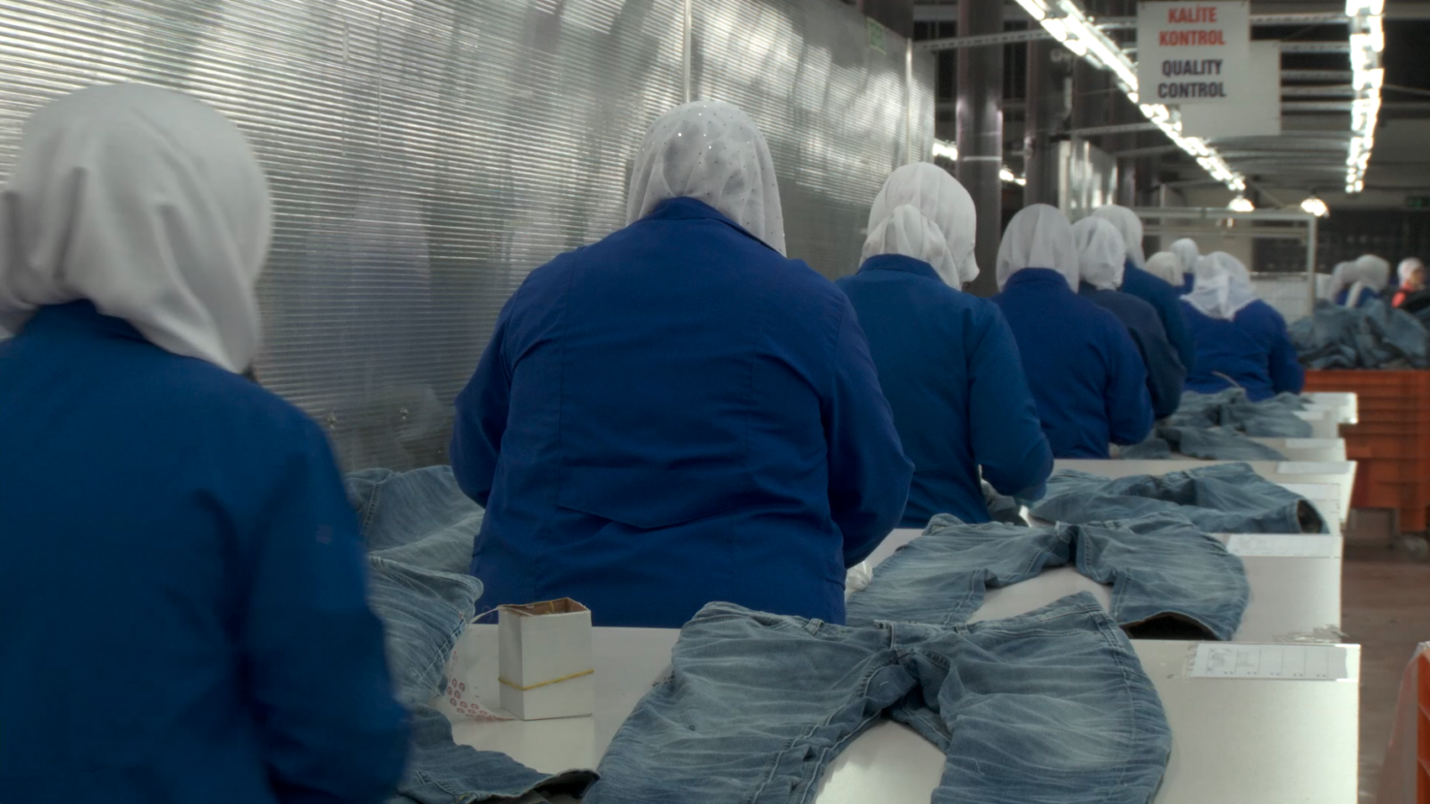 Factory workers making jeans.