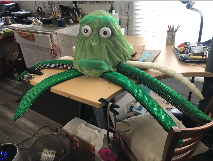 A green octopus puppet. 